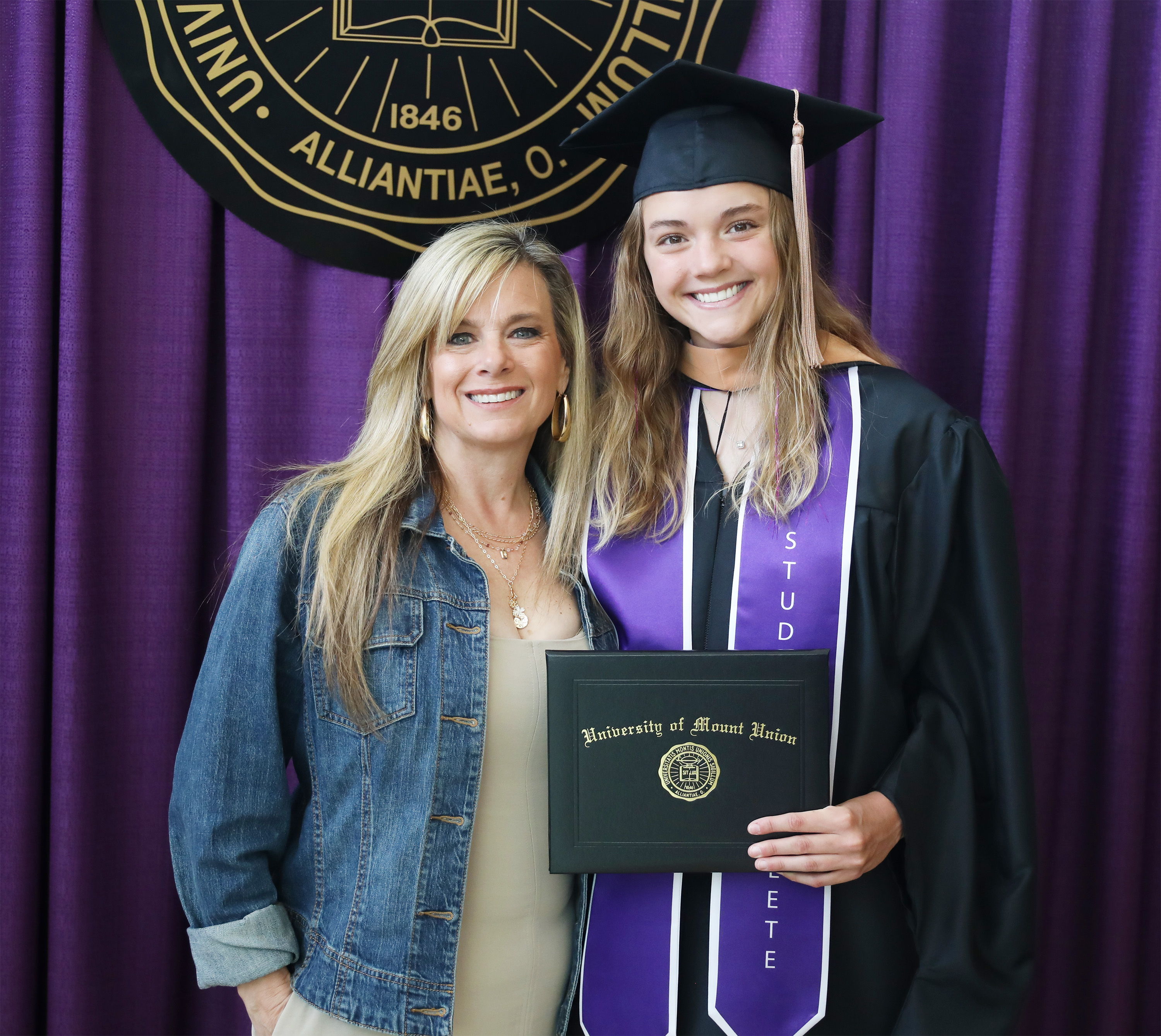 graduate posing with mother