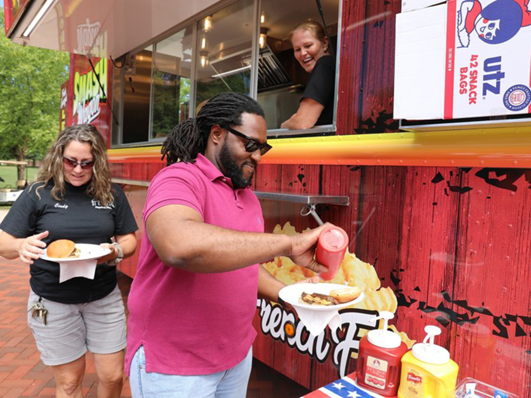 Staff members enjoying a food truck on campus