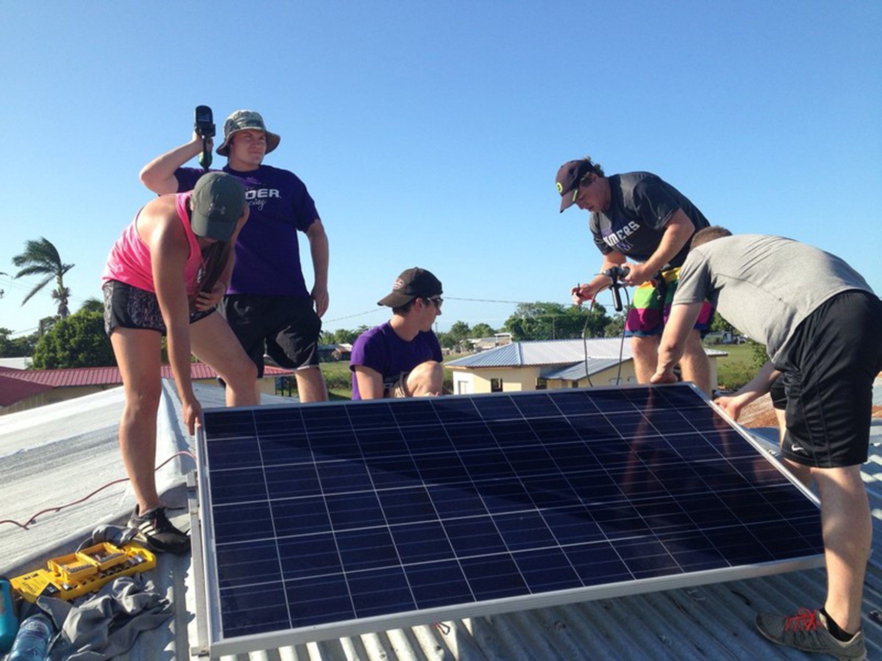 Students installing solar panels abroad