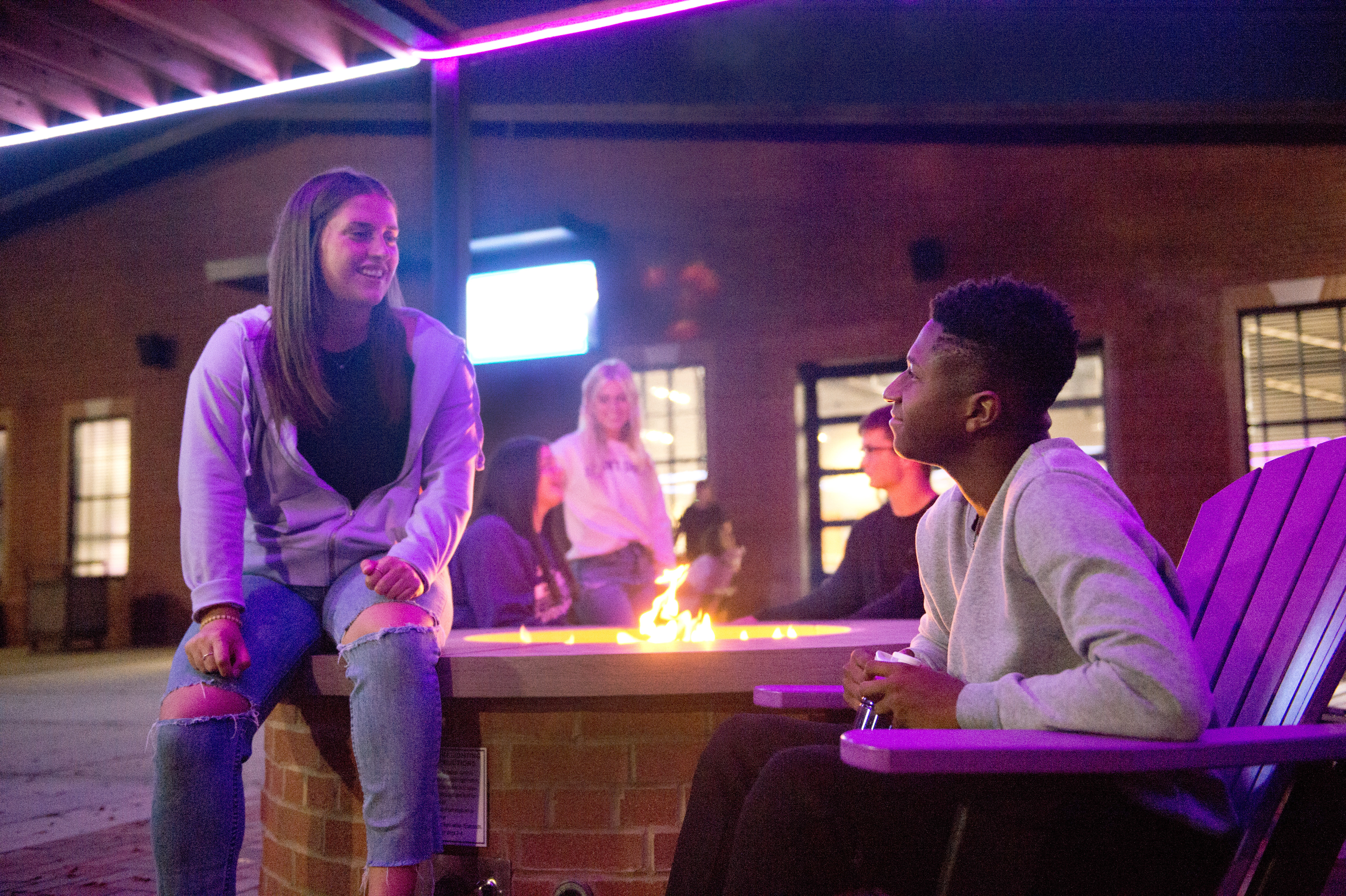 Students chatting at the fire pit