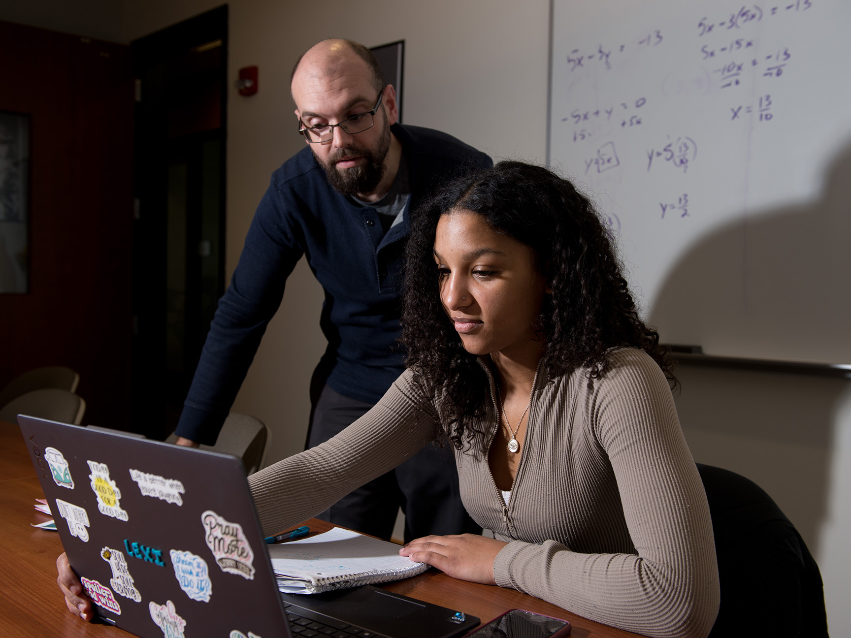 A student and faculty member working in the Math Center