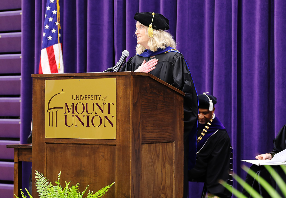 Braa speaking at podium