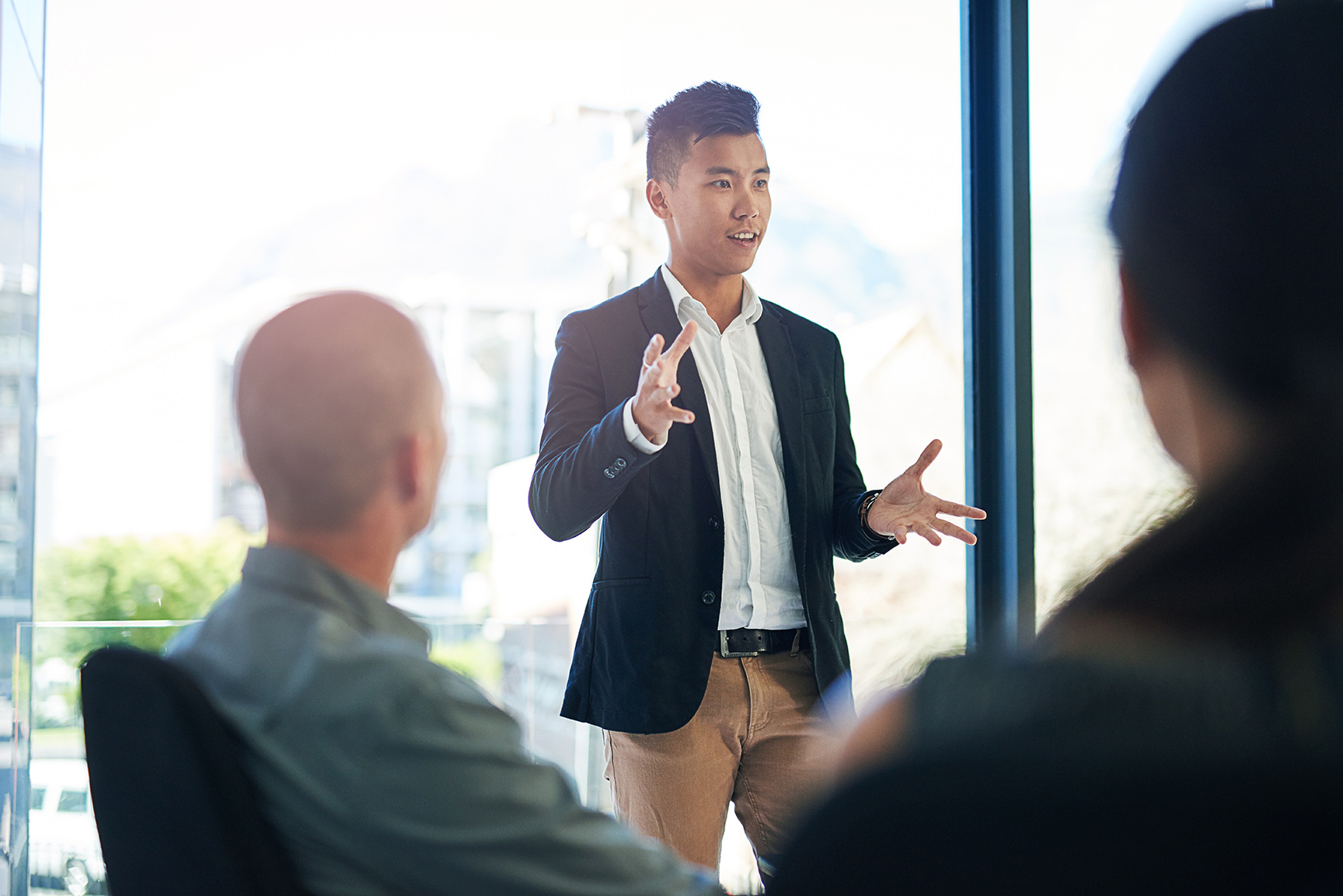 Business professional presenting to a group.