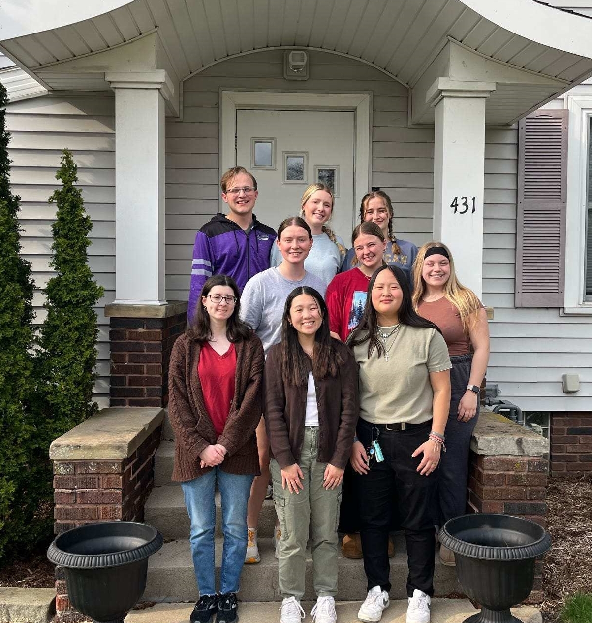 students standing in front of honors house