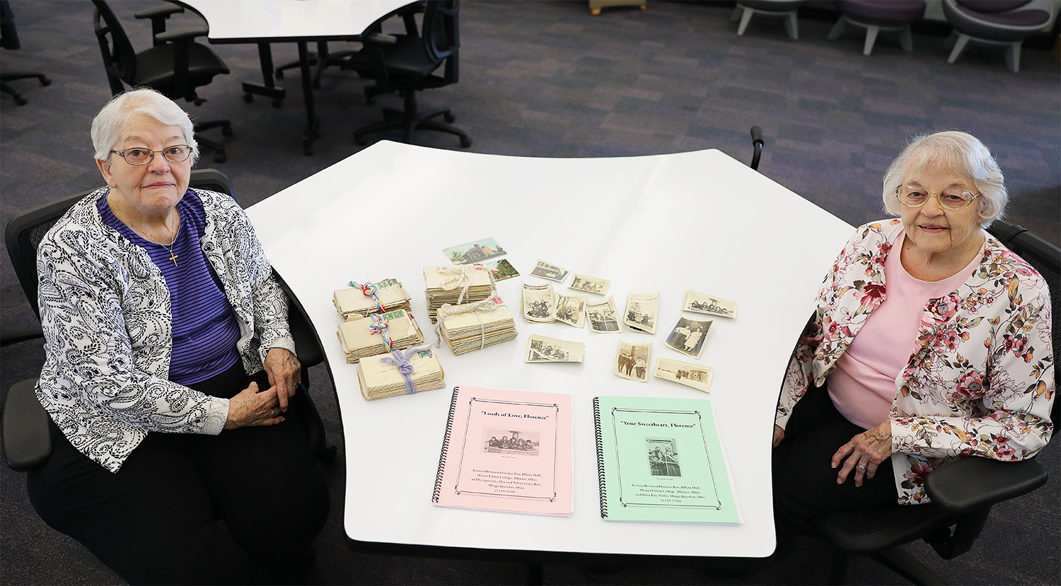 ellen sol on left and marcia thomas on right with archived pieces on table between them
