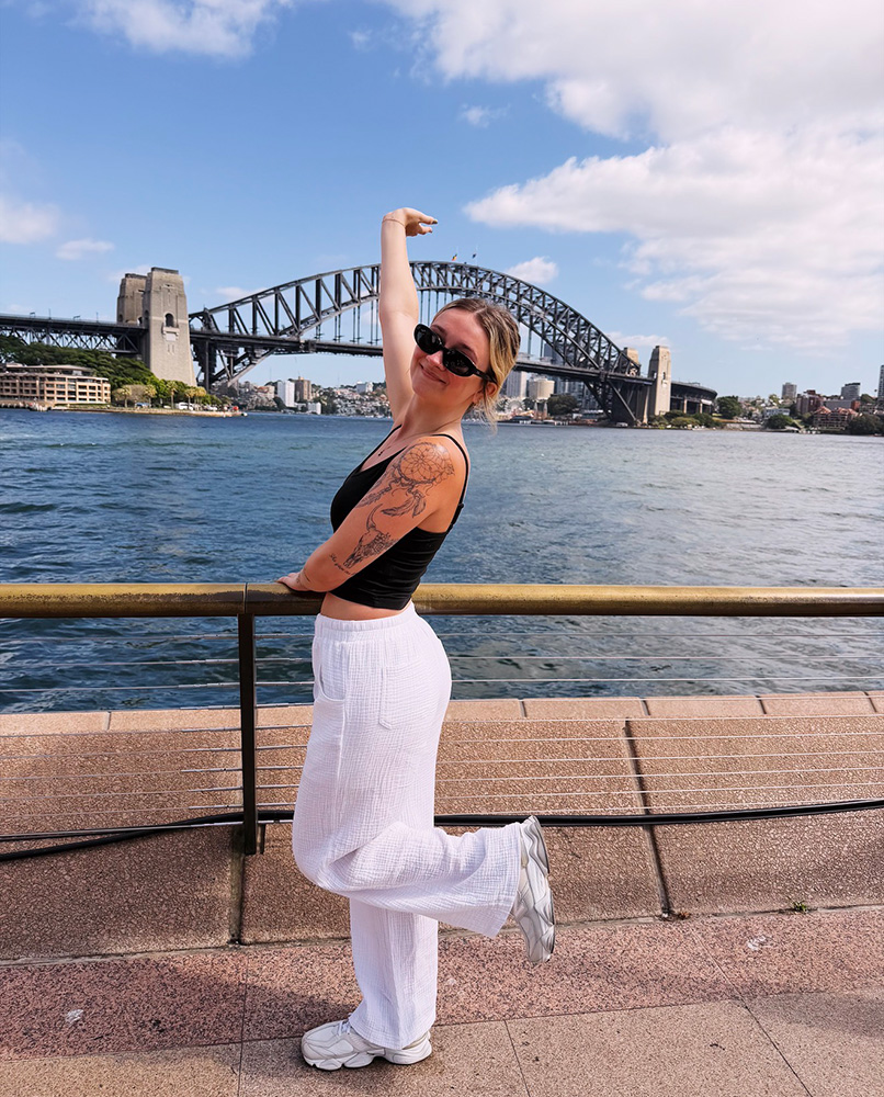 Bean standing in front of a bridge