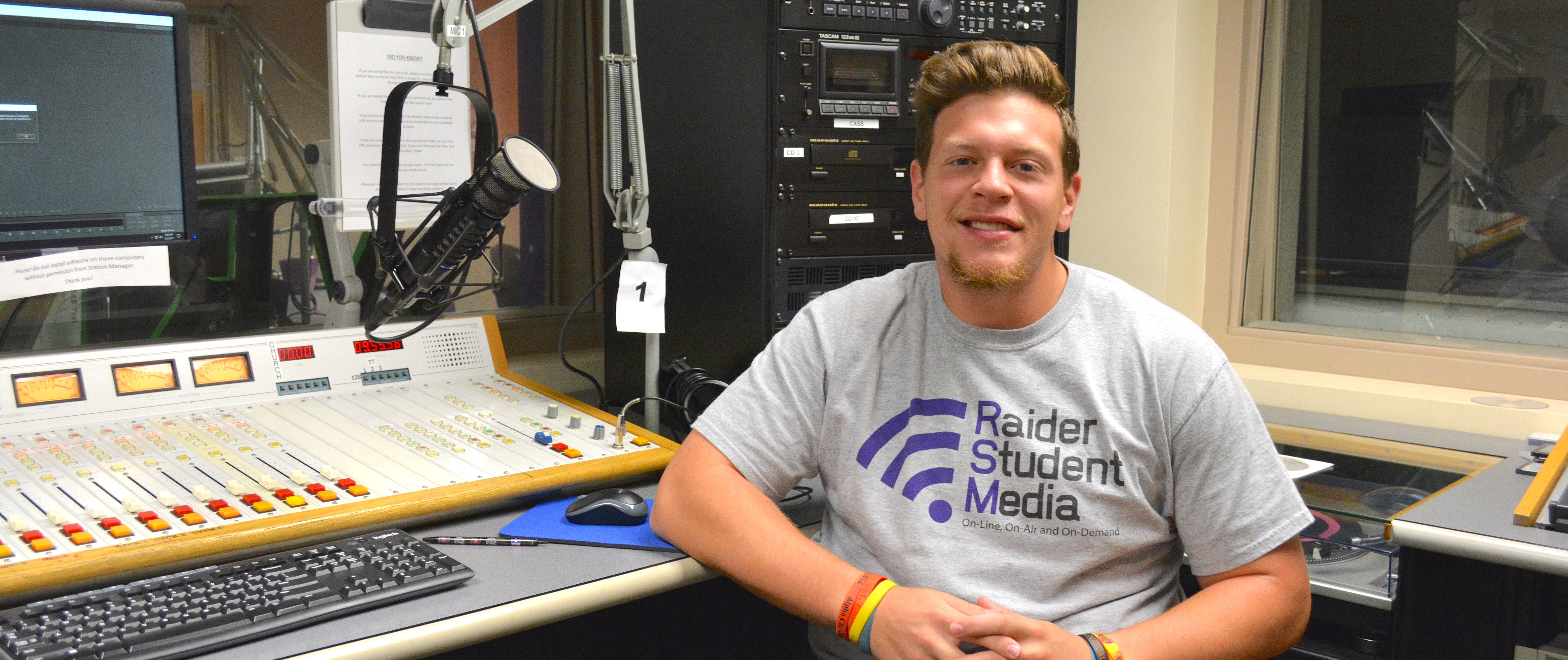 Joe Mertens sitting in a radio station booth 