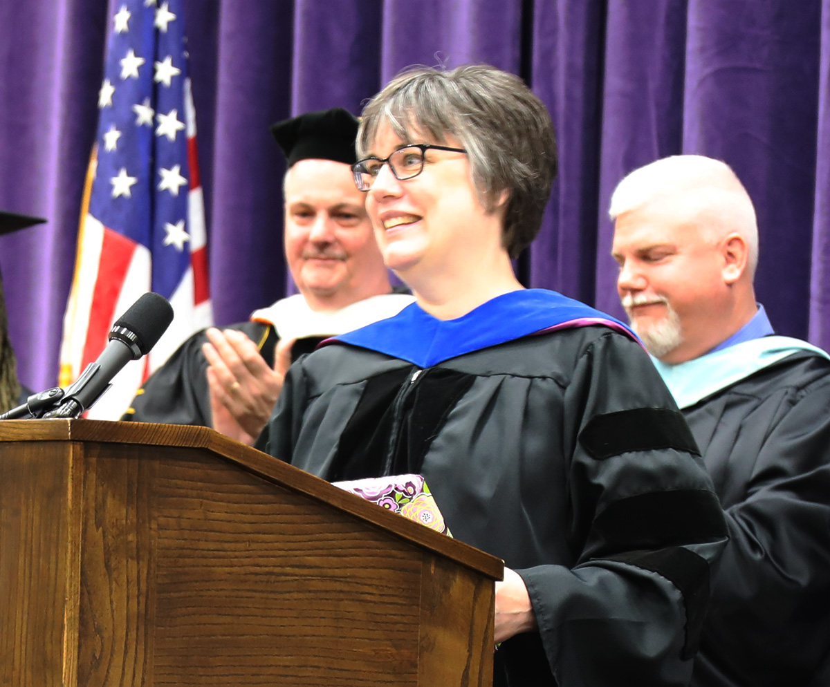 risley standing at podium