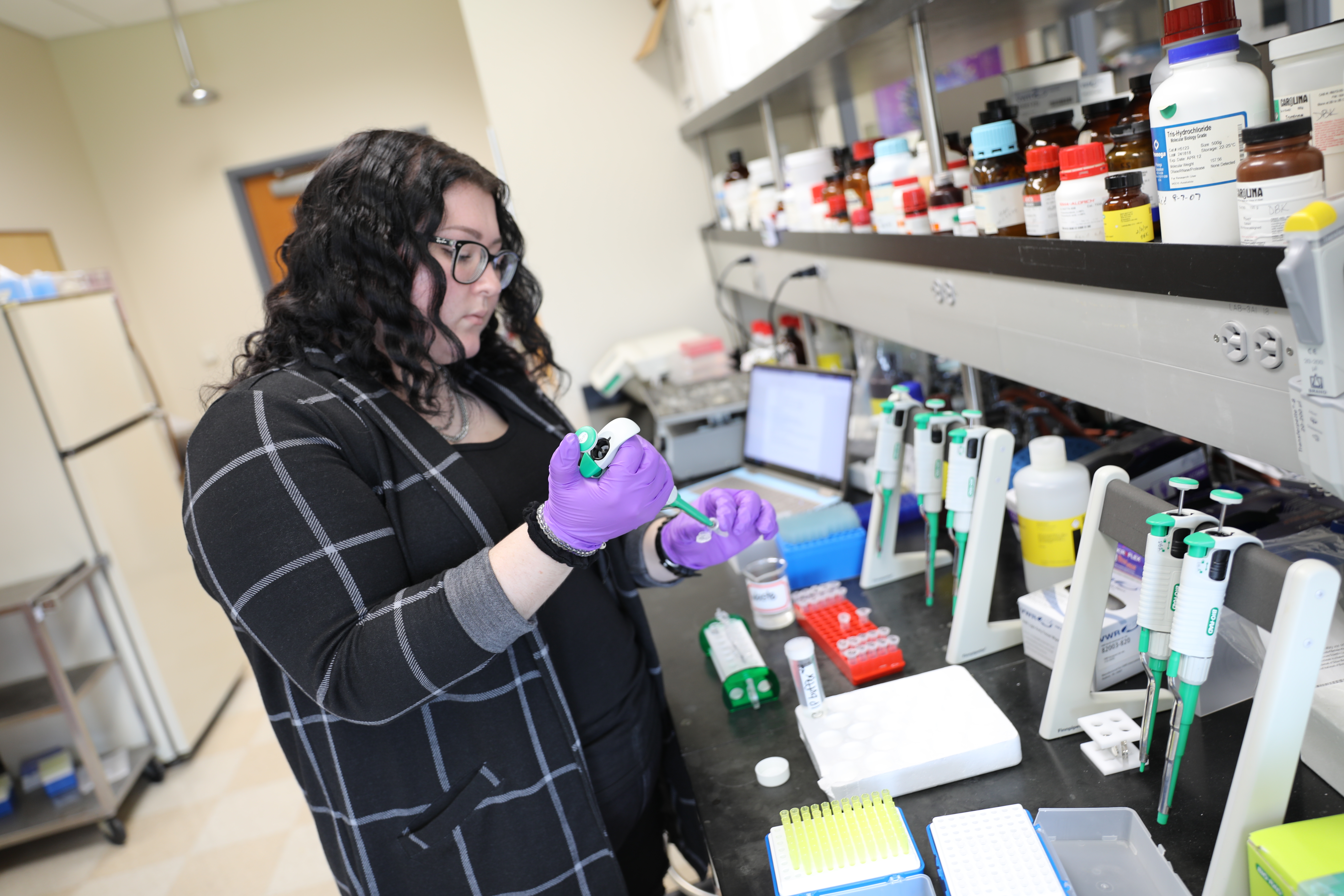 Biochemistry student in lab using chemicals