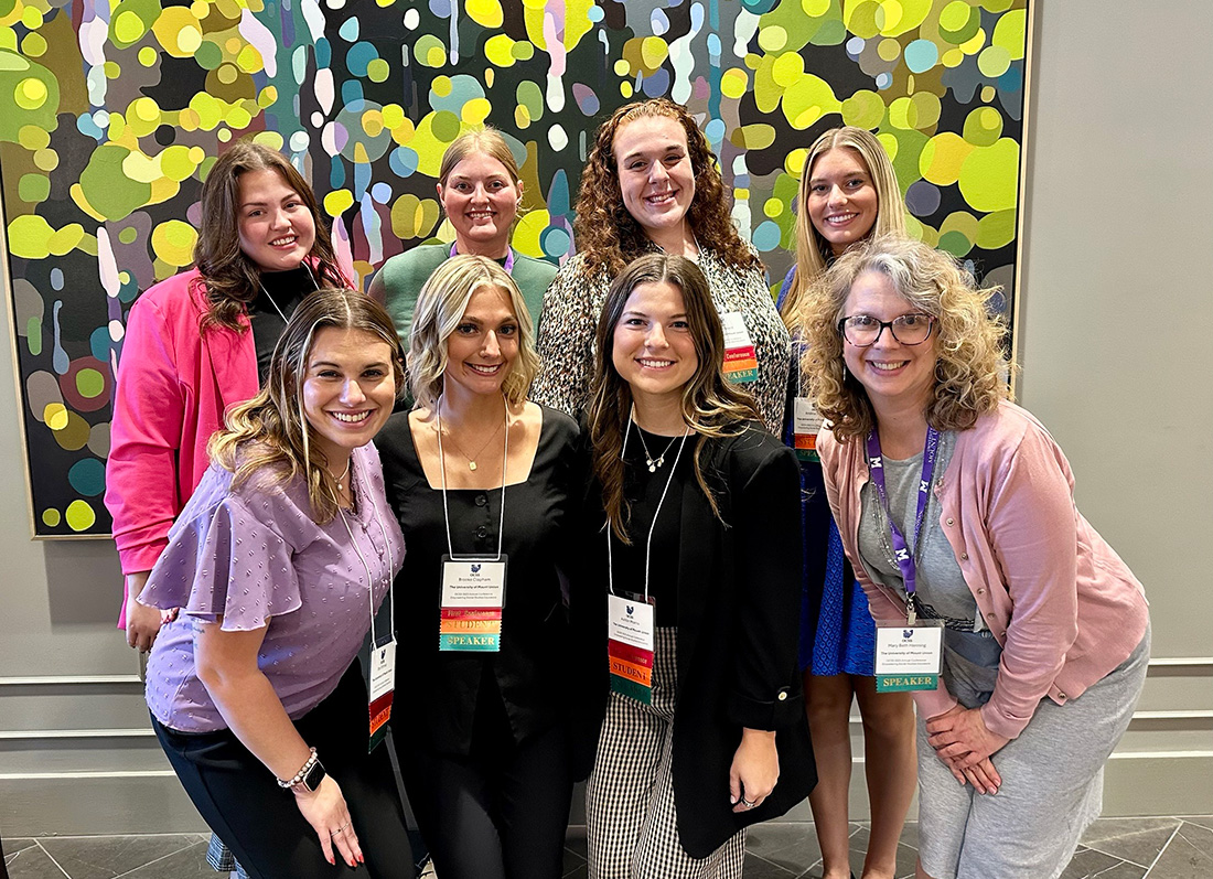 group of student educators with professor at conference