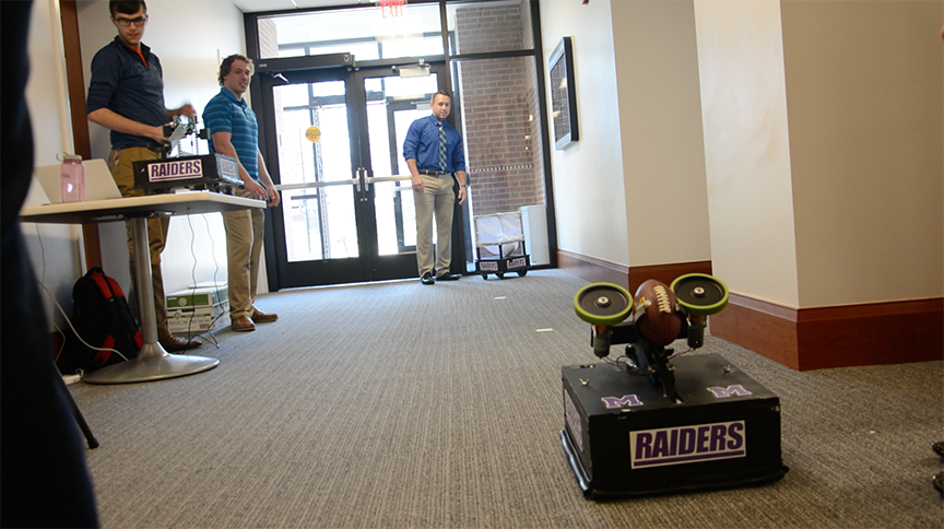 Students displaying robotic football players