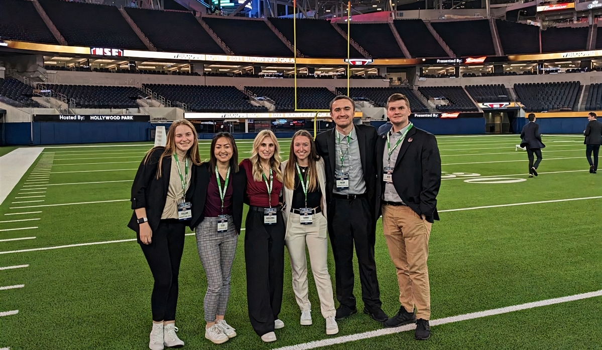 five students standing on field at sofi stadium