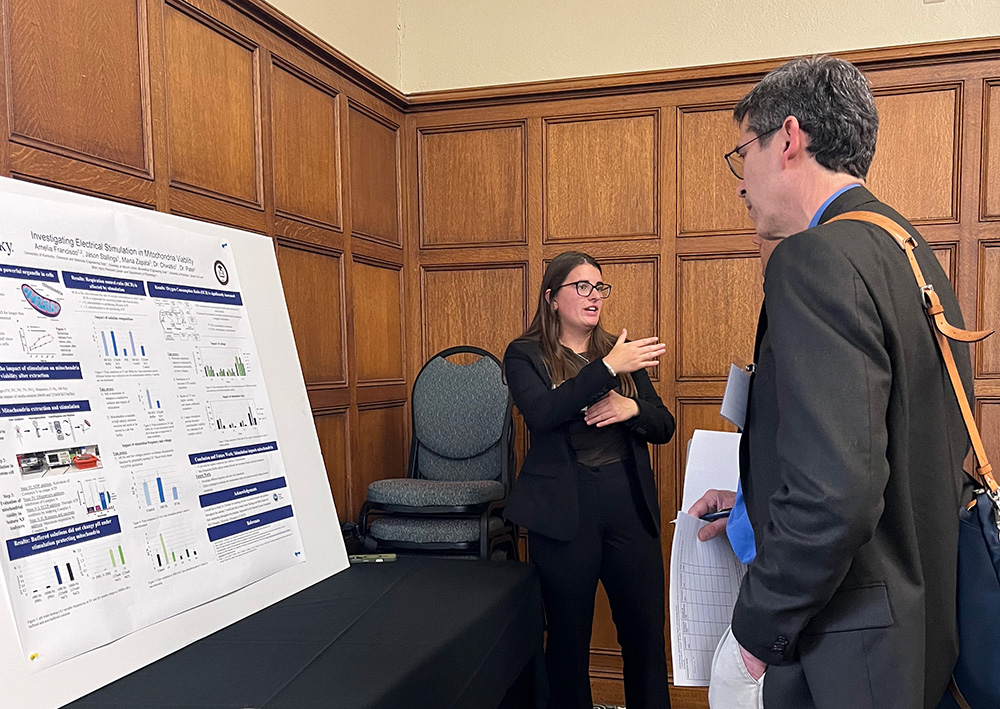 francisco presenting research to patron