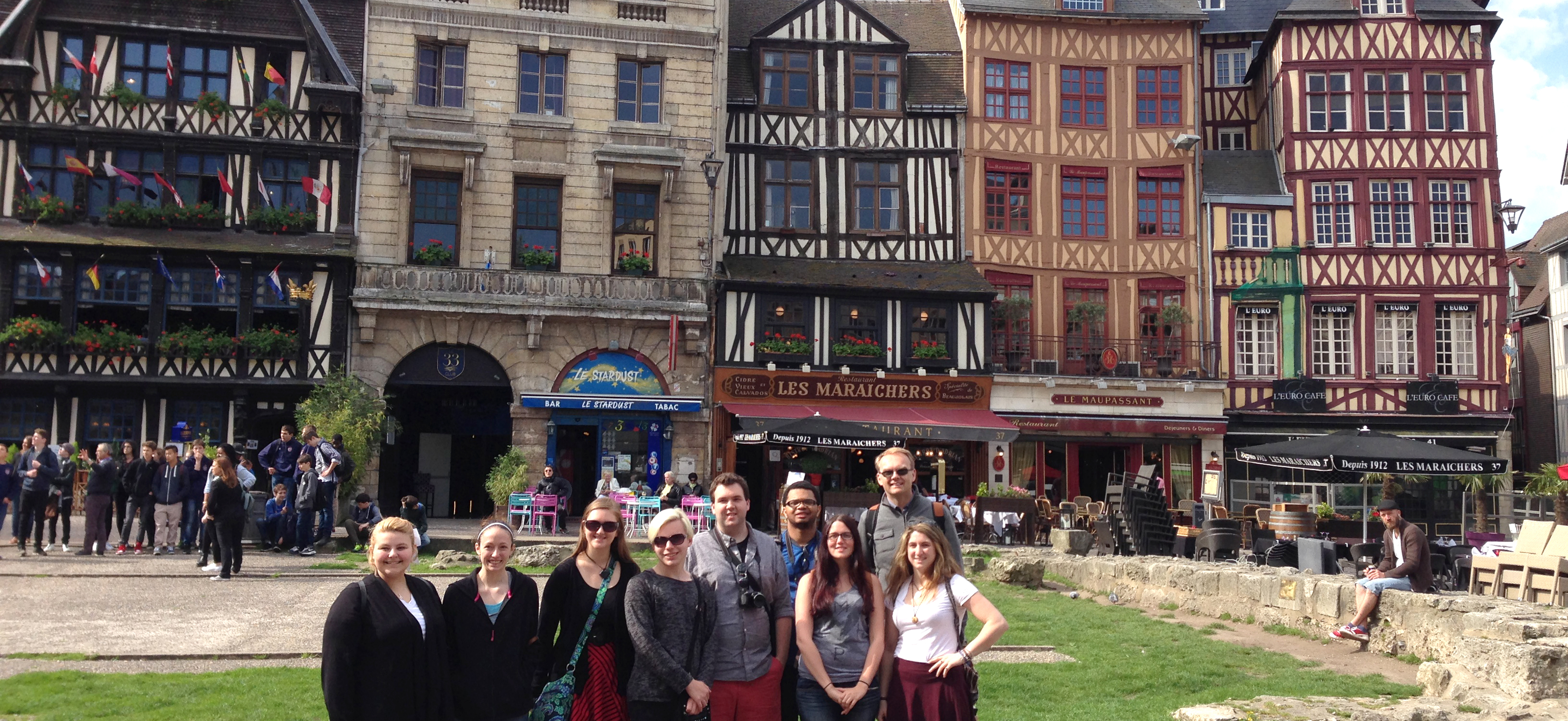 Professor with a group of students gathered in a French city