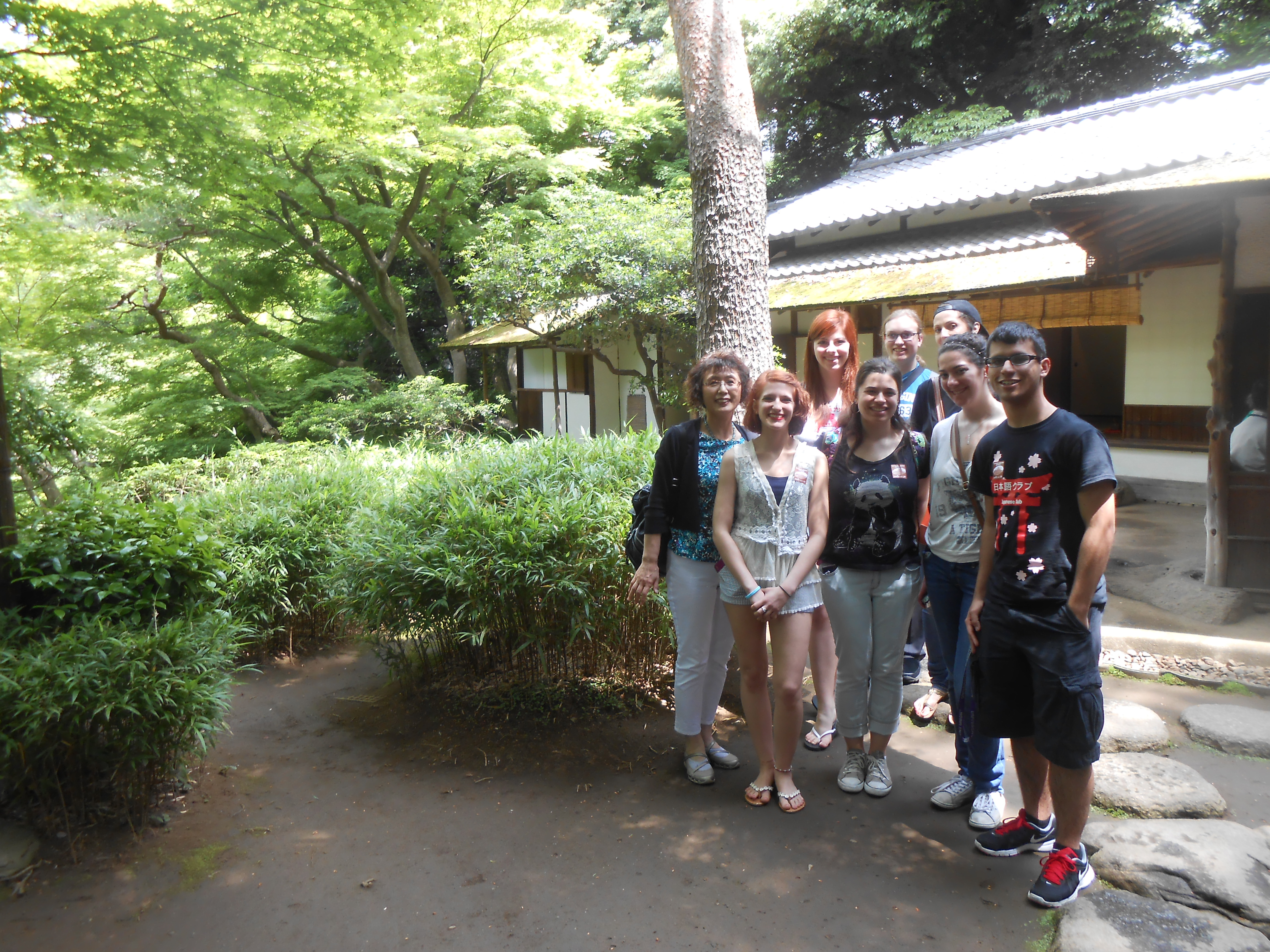 Japanese professor and students in front of teahouse in Japan