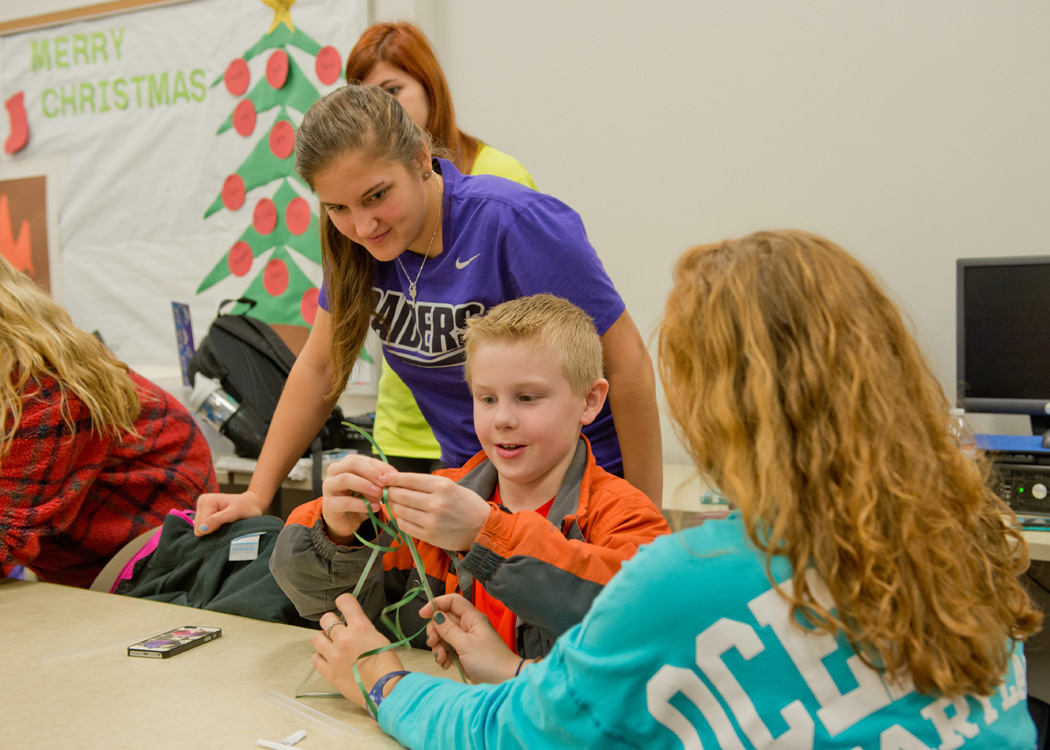 Early childhood education students teaching a child 