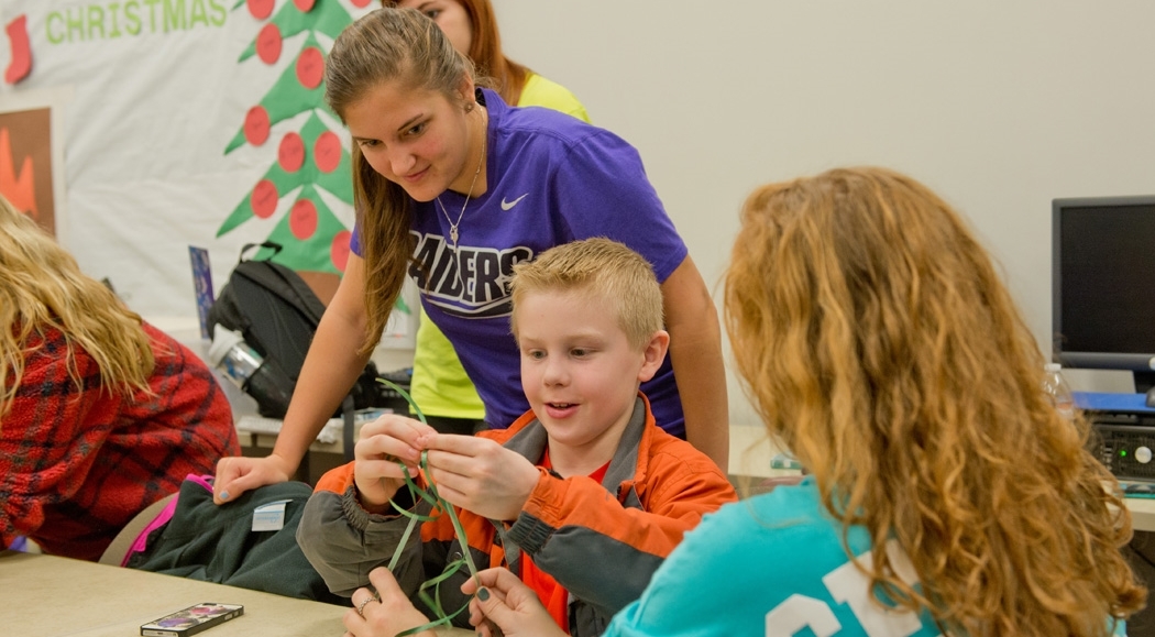 Early childhood education students teaching a child 