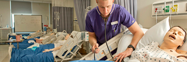 Nursing Student working on simulator in a lab