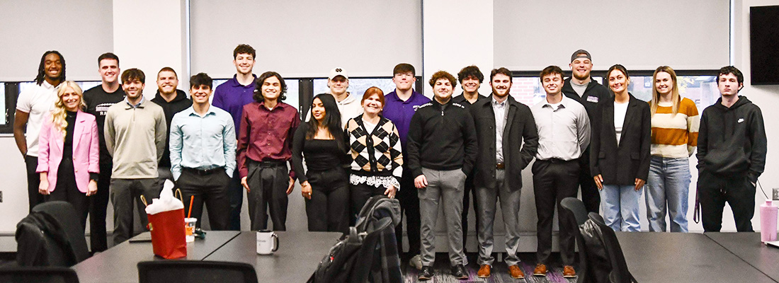 professor with students posed in class