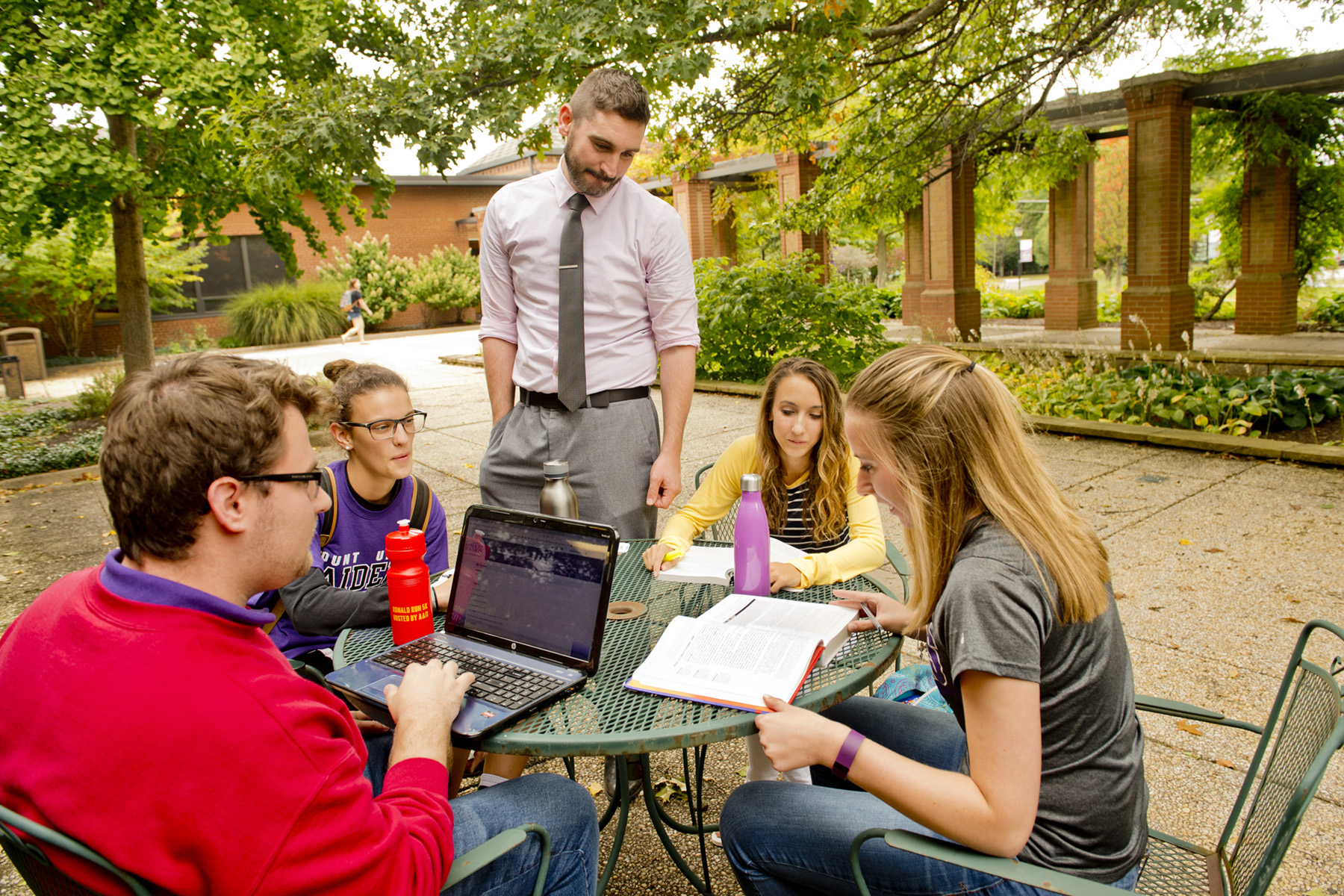 University of Mount Union students working with professor outdoors.