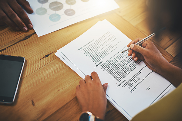 Two individuals completing paperwork