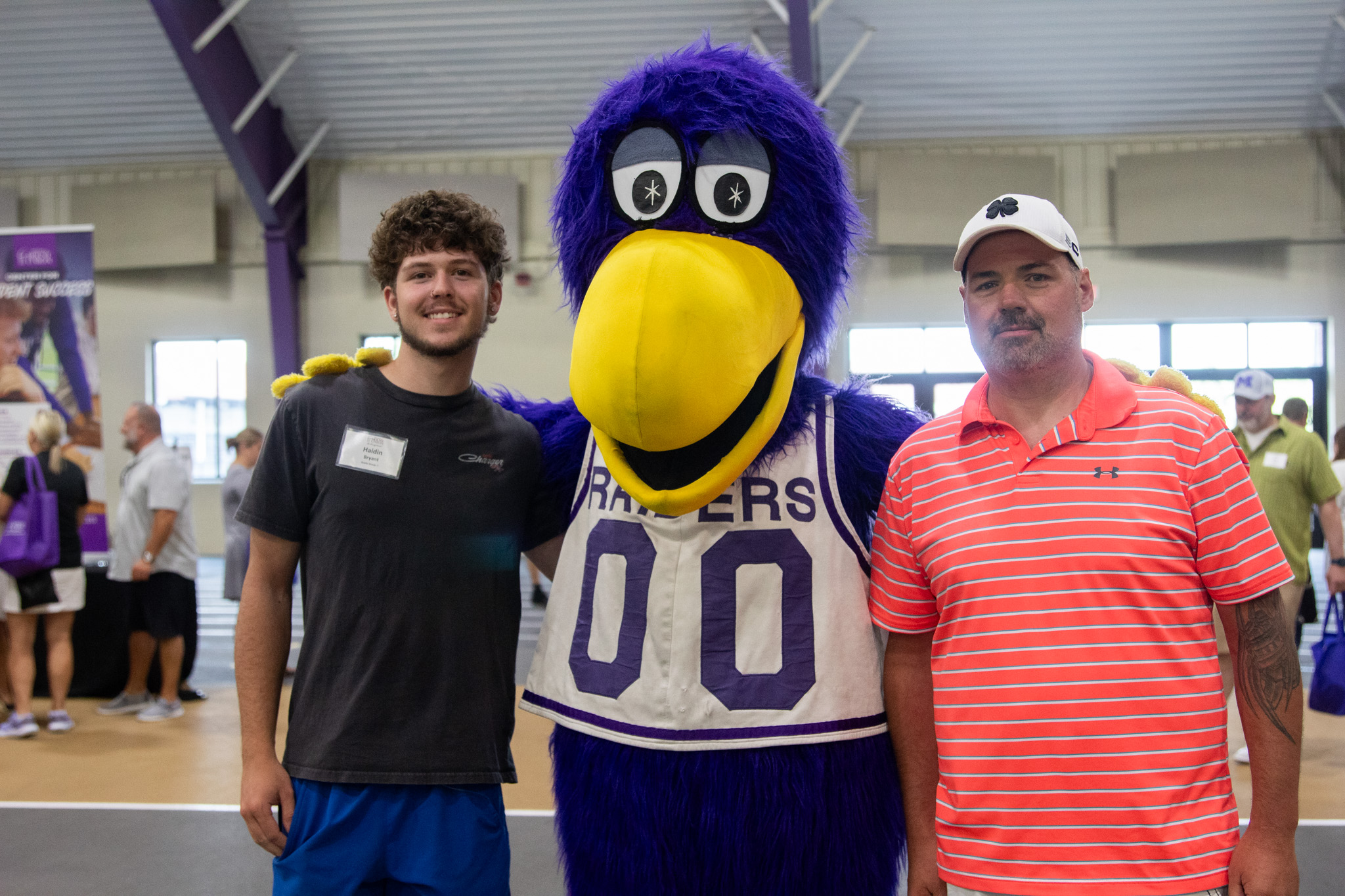 Father and Son with MUcaw purple bird mascot