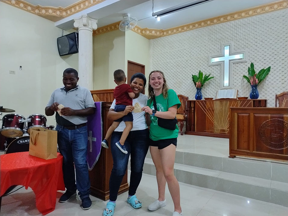 Cooper '26 with local Dominican residents