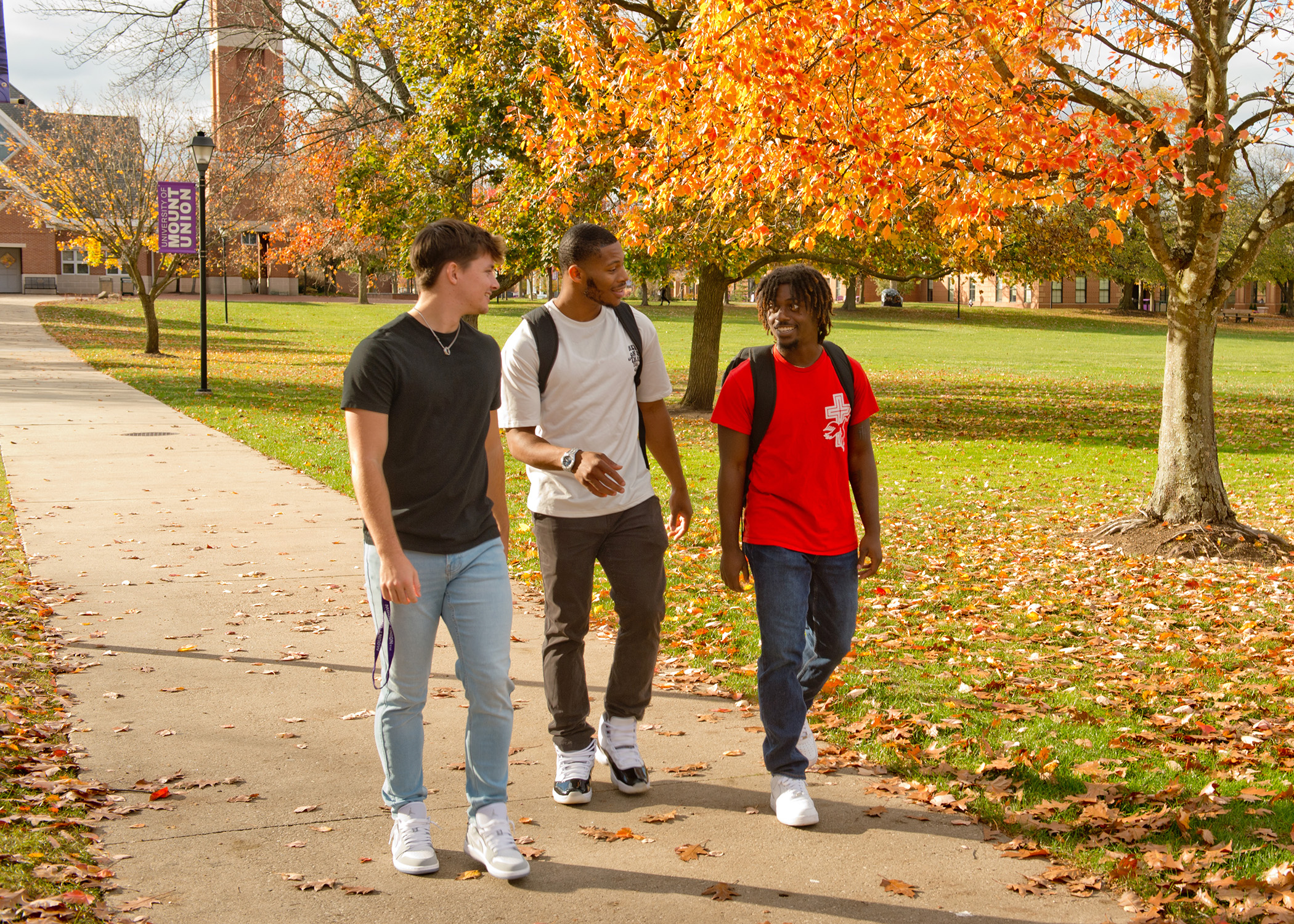 Mount Union students walking on campus during the fall season.