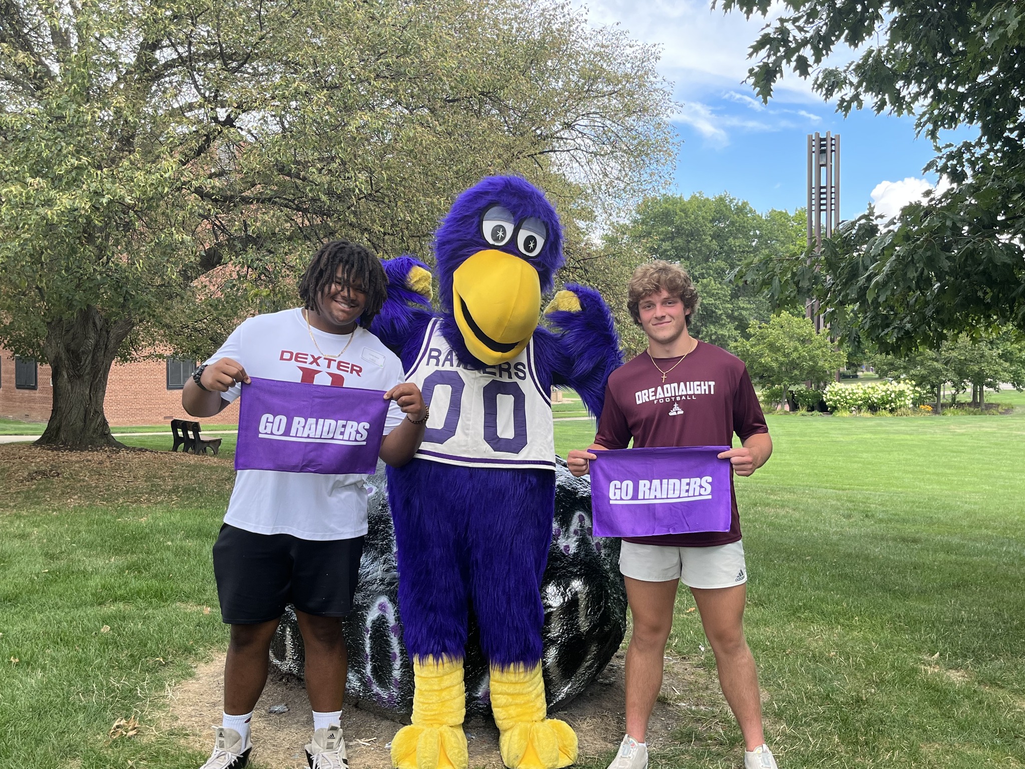Students touring on Mount Union's campus and posing with MUcaw, the mascot.