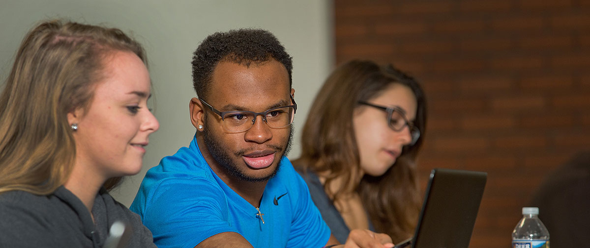 University of Mount Union students in classroom looking at a computer 