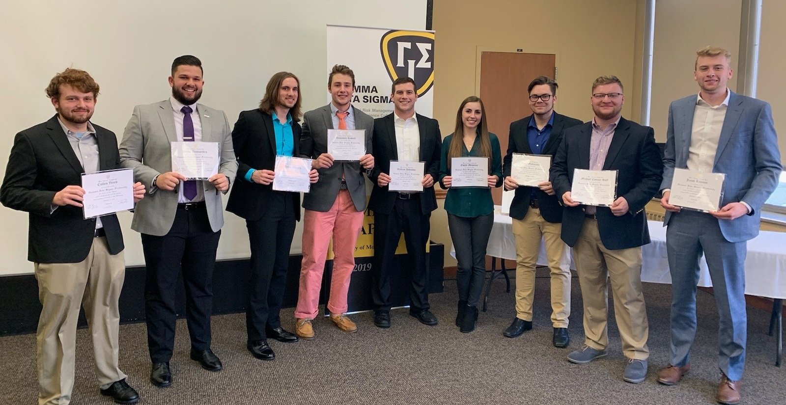 group of rmi students holding certificatesa