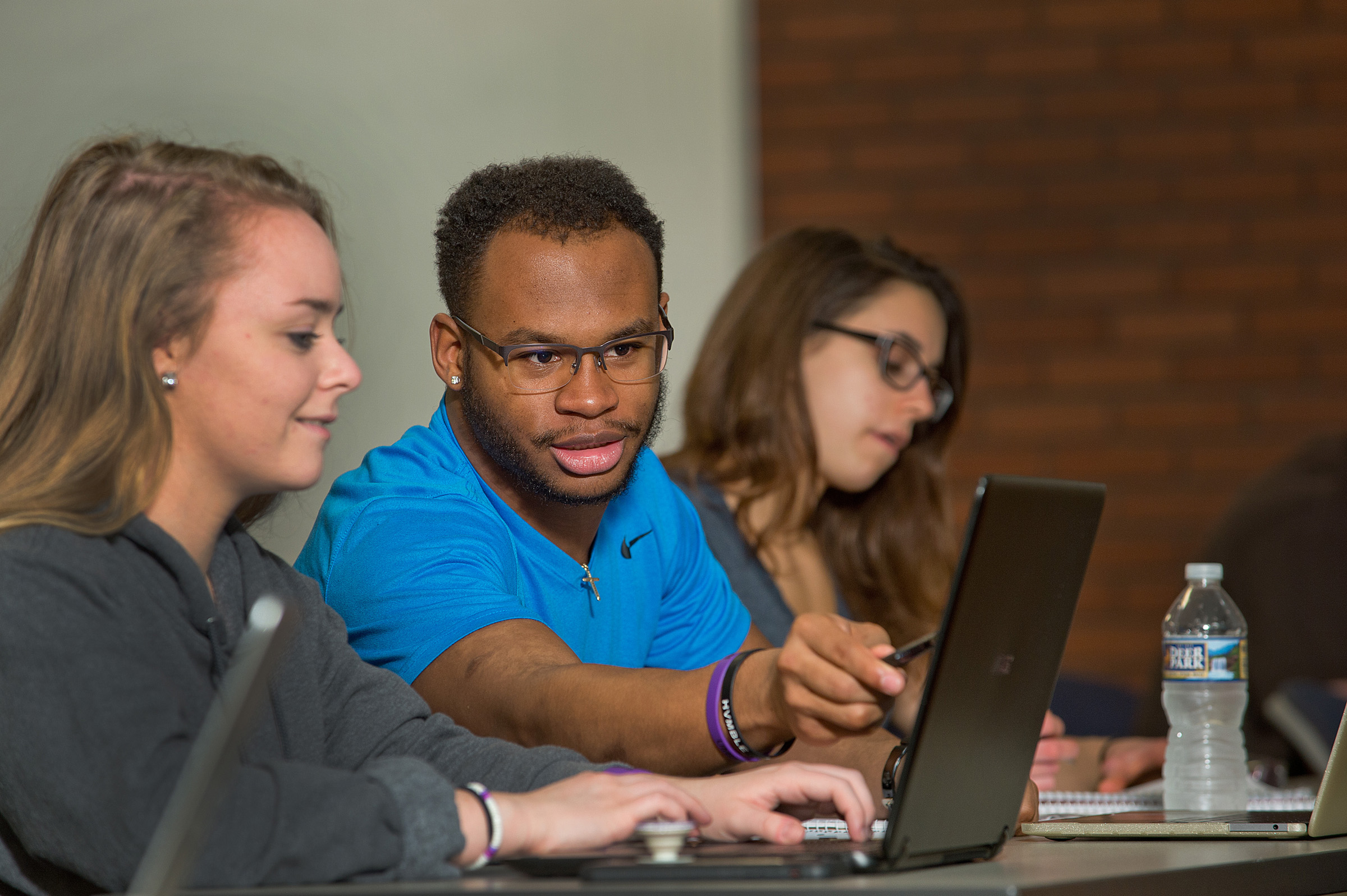 student pointing at computer 