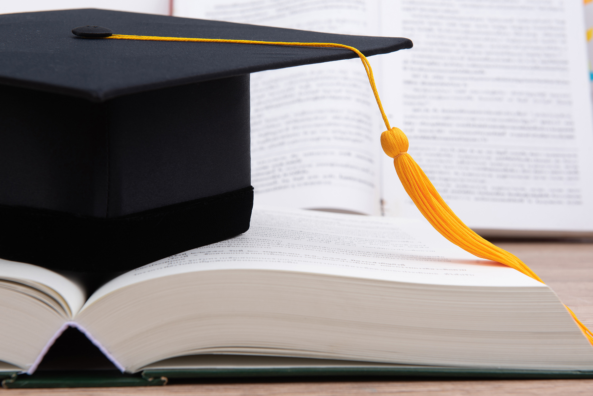 graduation cap on top of a book