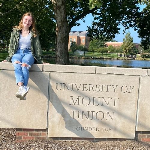 gracyn sage sitting on mount union sign